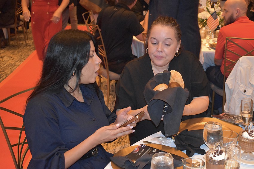 Patti Flores and Mayelin Rios enjoy the meal.