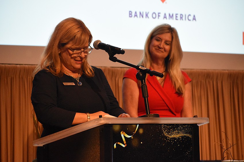 Kimberly Bleach of Bank of America reads out the recipient of the Breakthrough Business of the Year award, as Heather Kasten, president and CEO at The Greater Sarasota Chamber of Commerce, looks on.
