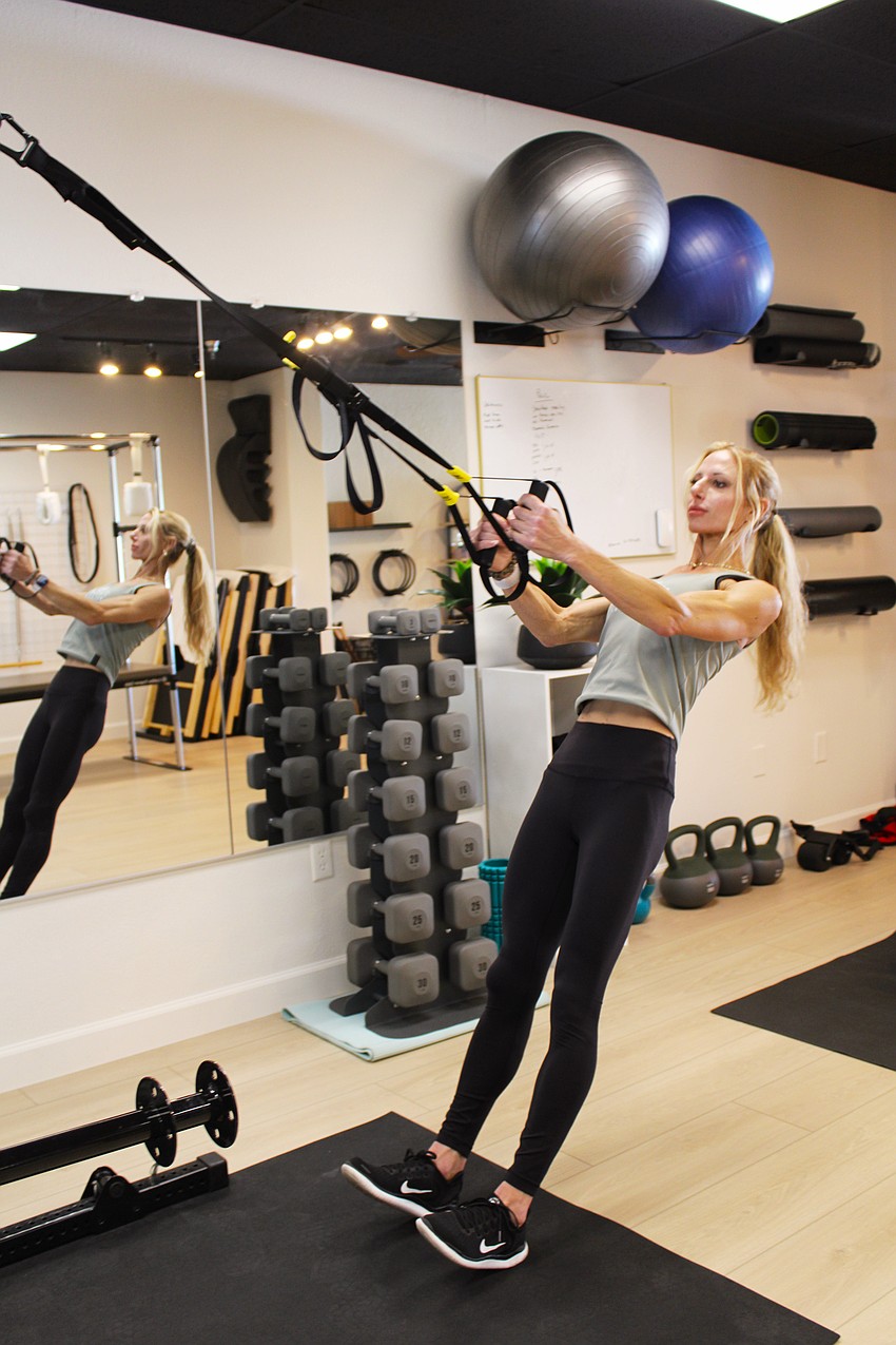 Paradise Pilates owner Julia Yesler, a certified personal trainer and Pilates instructor, demonstrates some of the assisted strength exercises her team teaches.
