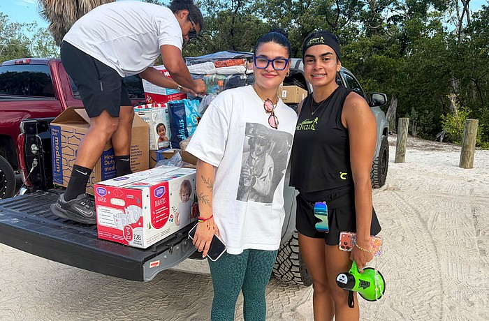 Carla Paola Ventura, organizer of Sunday's aid drive to support Venezuelan earthquake survivors, and Noemi Ottenwalder, founder of the new Latinas Run Club that hosted the drive, load supplies into the truck after the morning run on Lido Key. Ventura said while the devastation is far-reaching, small contributions made by many people amount to a big difference.
