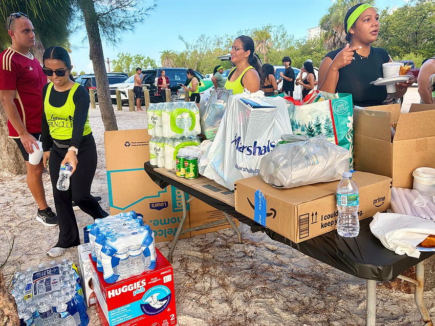 After finishing their 3.7-mile run up and down Lido Key, participants in Sunday's Latinas Running Club filled a donation table to the brim with supplies for Venezuelan earthquake survivors.