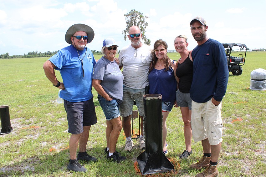 Mark Mullen, Marsha Parks, Travis Barfield, Martha Barfield, Ashley Bechler, and Matt Bechler worked in 100-degree heat to set up their July 4 fireworks show in Myakka City.