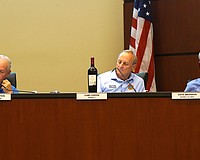 Town Commissioner Gary Coffin brought a bottle of wine to Monday's special meeting to help provide context to what a potential increase in Longboat Key millage rate would mean to a property owner.
