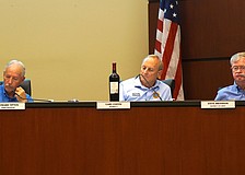 Town Commissioner Gary Coffin brought a bottle of wine to Monday's special meeting to help provide context to what a potential increase in Longboat Key millage rate would mean to a property owner.