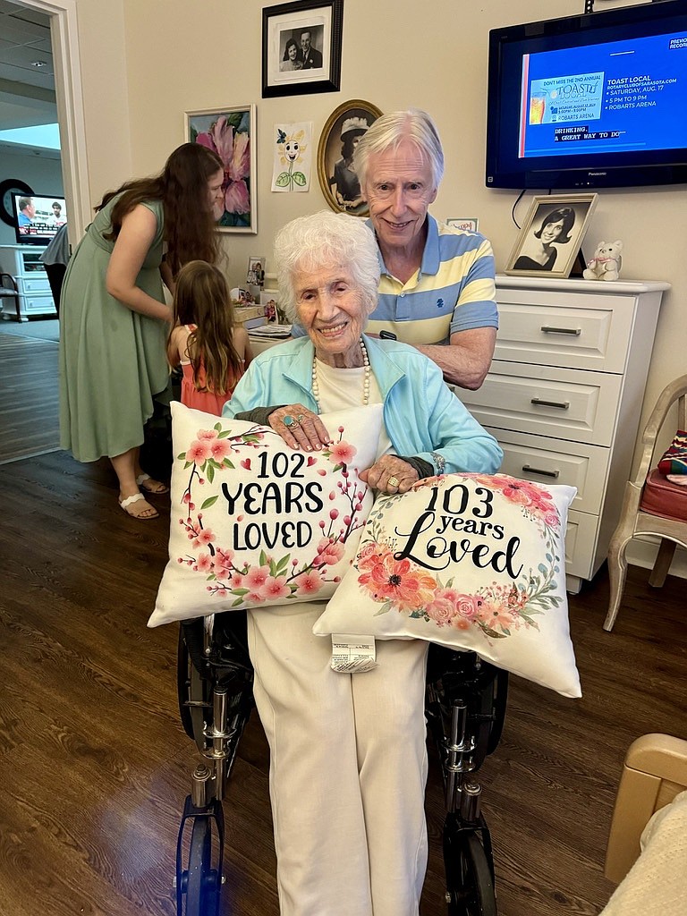 Marsha Kaplan's husband David Kaplan poses with Sylvia Waller and pillow gifts from her 102nd and 103rd birthdays. Marsha Kaplan's husband David Kaplan poses with Sylvia Waller and pillow gifts from her 102nd and 103rd birthdays.
