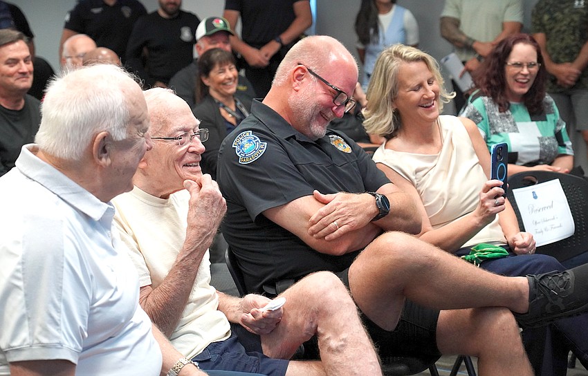 Officer Tripp Schwenk and wife, Heather, enjoy an amusing anecdote during his retirement ceremony from the Sarasota Police Department. Officer Tripp Schwenk and wife, Heather, enjoy an amusing anecdote during his retirement ceremony from the Sarasota Police Department.