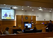 Tony Barrett appears before Judge Gilbert A. Smith Jr. July 1. He's on the screen. His attorney Richard Reinhart appeared in person.