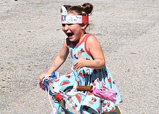 Emersyn Baker, 3, woke up Thursday morning eager to ride in the bike parade at the Kiddie Academy.