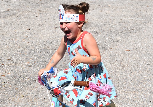 Emersyn Baker, 3, woke up Thursday morning eager to ride in the bike parade at the Kiddie Academy.