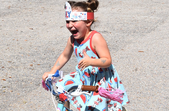 Emersyn Baker, 3, woke up Thursday morning eager to ride in the bike parade at the Kiddie Academy.