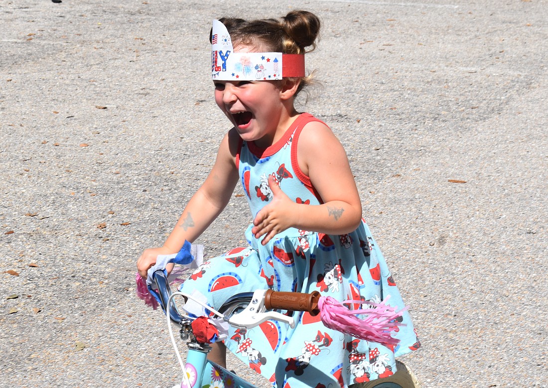 Emersyn Baker, 3, woke up Thursday morning eager to ride in the bike parade at the Kiddie Academy.