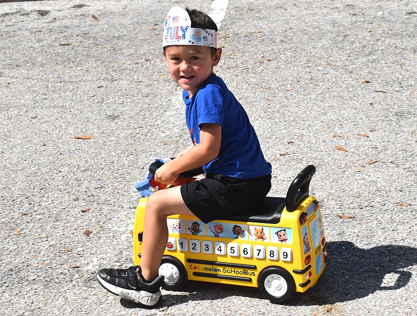 Otto Wilson, 3, chose to ride a school bus in the bike parade.
