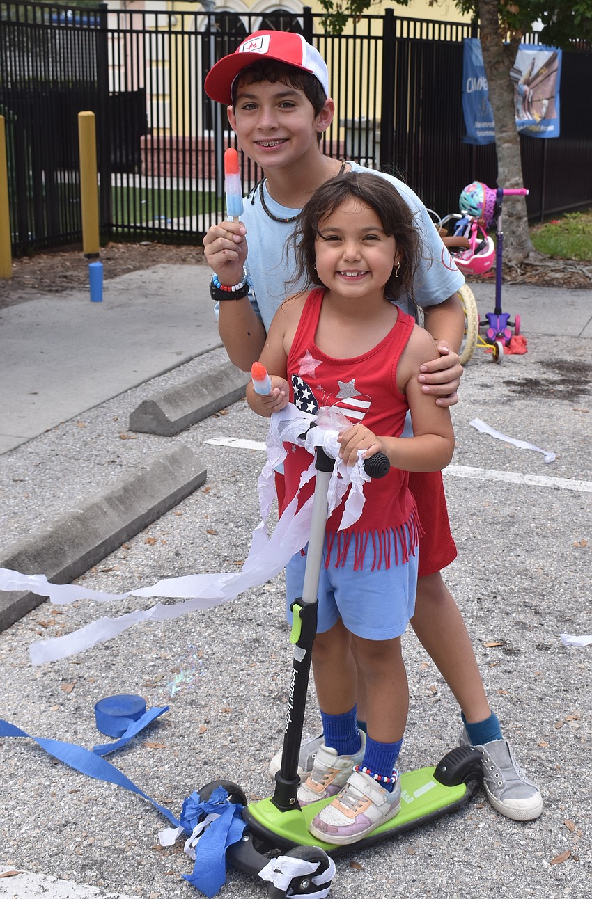 Ten-year-old Giovanni Soto and his sister, 6-year-old Lyla Soto, are happy to decorate their scooters and celebrate the Fourth of July.