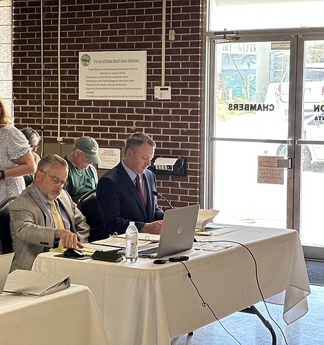 Former Flagler Beach Fire Chief Stephen Cox (right) sits with his attorney, Gary Wilson, during a July 1 Personnel Review Board hearing challenging Cox's termination. Photo by Rich Carroll.