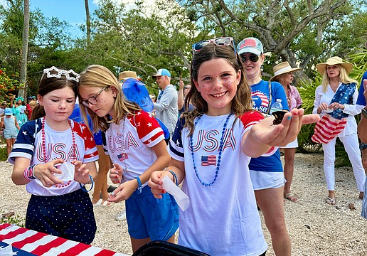 Lucy Clark and Carlin and Ellie Mackintosh, granddaughters of Longboat Key artist May Lou Johnson, help release the first of 250 butterflies at Freedom Fest. The Fourth of July festivities also included a parade, canine costume contest, rededication of Bicentennial Park and family activities.