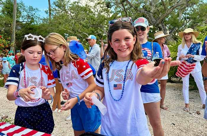 Lucy Clark and Carlin and Ellie Mackintosh, granddaughters of Longboat Key artist May Lou Johnson, help release the first of 250 butterflies at Freedom Fest. The Fourth of July festivities also included a parade, canine costume contest, rededication of Bicentennial Park and family activities.