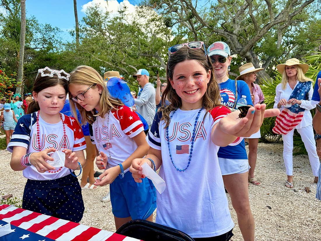 Lucy Clark and Carlin and Ellie Mackintosh, granddaughters of Longboat Key artist May Lou Johnson, help release the first of 250 butterflies at Freedom Fest. The Fourth of July festivities also included a parade, canine costume contest, rededication of Bicentennial Park and family activities.