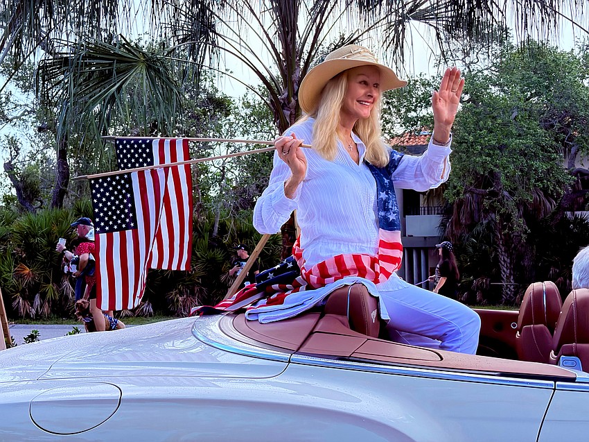 Parade Marshal Susan Phillips waves to the crowd at Freedom Fest.