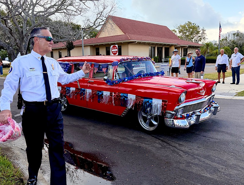 Longboat Key Fire Rescue Chief Paul Dezzi waves forward JoDene Moneuse, who won the 