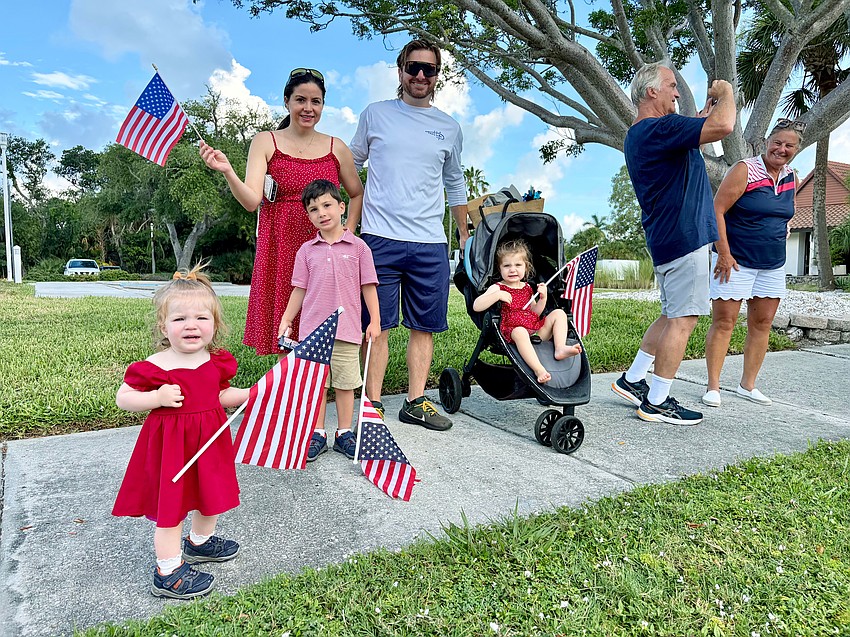 Members of the Carney family, waving the stars and stripes, came out to see the Freedom Fest parade on Longboat Key.