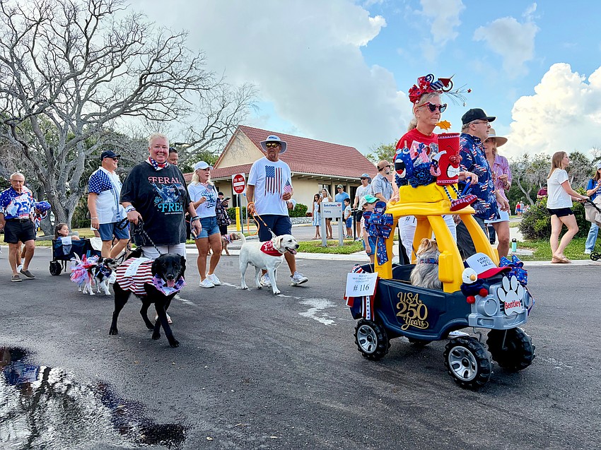 Many festival-goers said the costumed dogs were their favorite part of this year's Fourth of July Parade. Above, Reneé Fannin joins in the Rotary Club of Longboat Key-hosted contest.