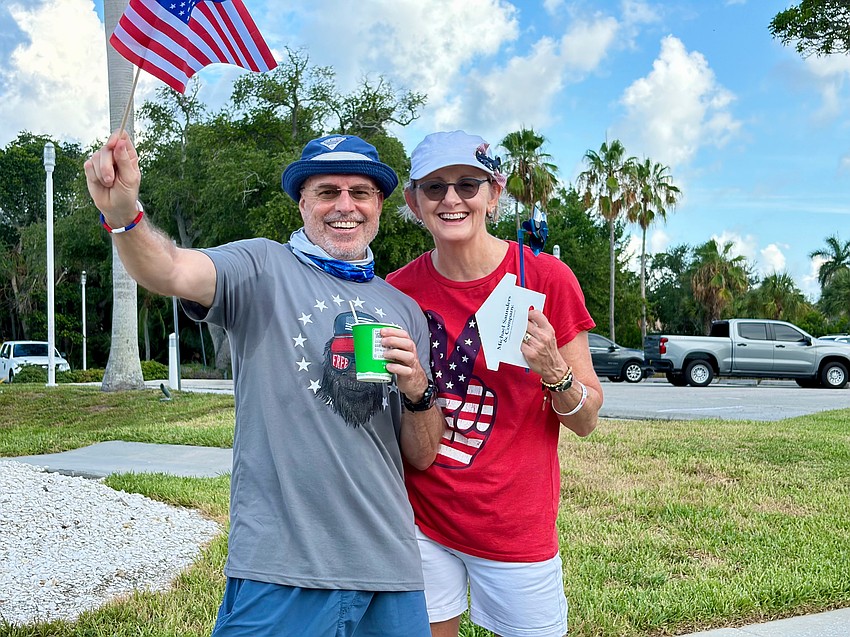 Spectators John and Sally Myer save the stars and stripes at Freedom Fest.