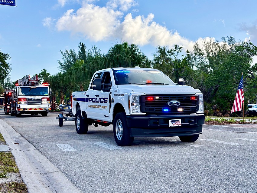 Representatives from the Longboat Key Police Department flash red, white and blue lights at the Freedom Fest parade.
