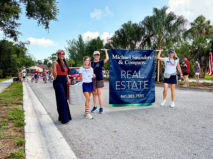 The team from Michael Sanders & Company walks in the Freedom Fest parade.