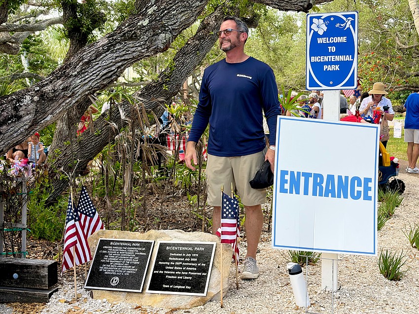 Longboat Key Public Works Director Charlie Mopps unveils the new plaque celebrating the country's history at Bicentennial Park.