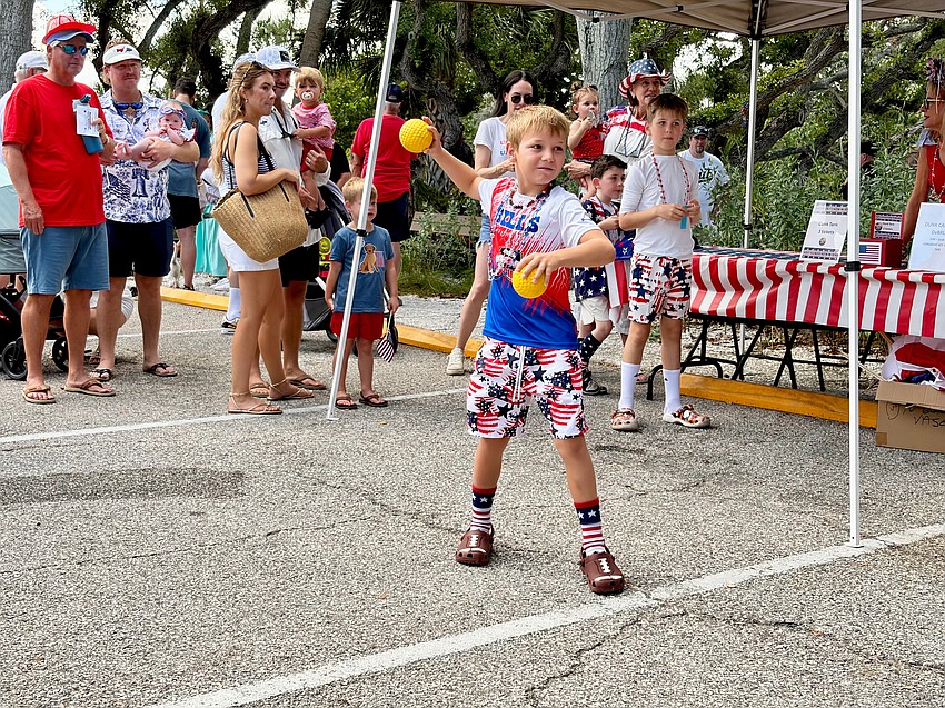 Easton Wallace lines up a shot at the dunk tank at Longboat Key's Freedom Fest.