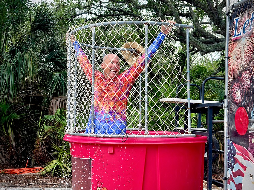 Cameron DeBruin of Longboat Key Taxi & Limo makes a splash in the dunk tank at Freedom Fest.