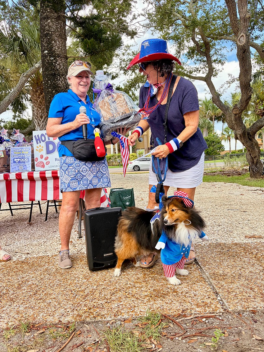 Barbara Diznoff and Micky, who won recognition in last year's digital 'Hot Diggity Dog!' costume contest, pull off a win for the most creative costume at this year's in-person competition. They collected their award from Rotary Club of Longboat Key member Carol Erker.
