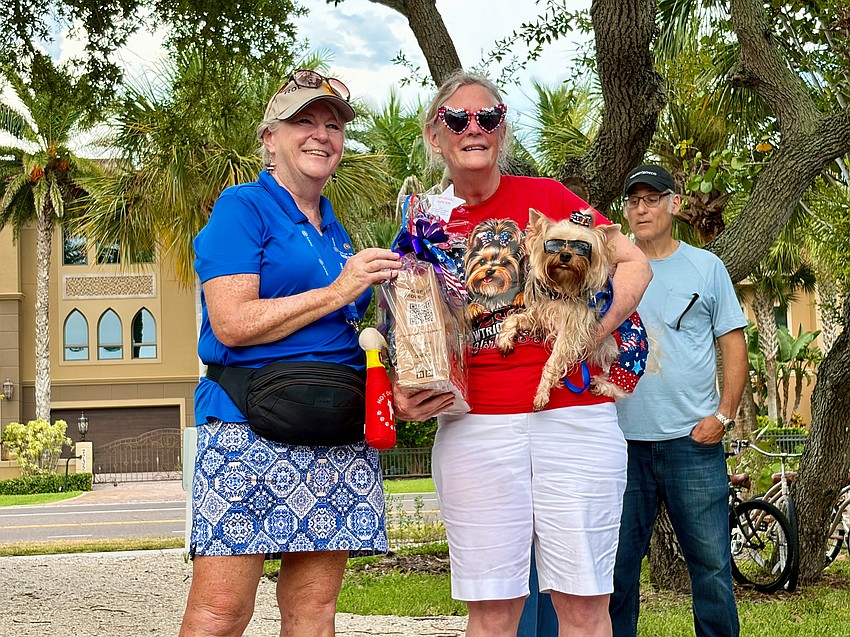 There's no mistaking where this Yorkie belongs. Bentley and owner Gail Yeager collect their honorable mention award from Carol Erker for the 'Hot Diggity Dog!' contest.