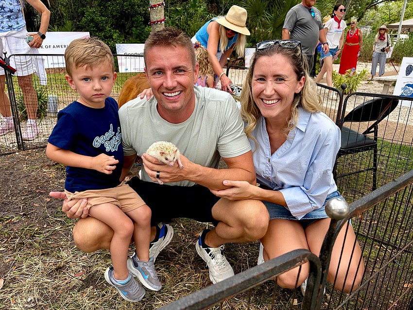 Justin and Barbara Benz introduce 3-year-old Ben to a white hedgehog at the Freedom Fest petting zoo.