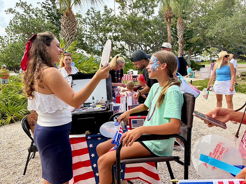 Addie Esposito gives the stamp of approval on her patriotic face paint at Freedom Fest.