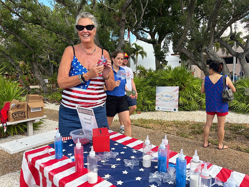Patrice Fanning runs the colorful sand craft table at Freedom Fest.