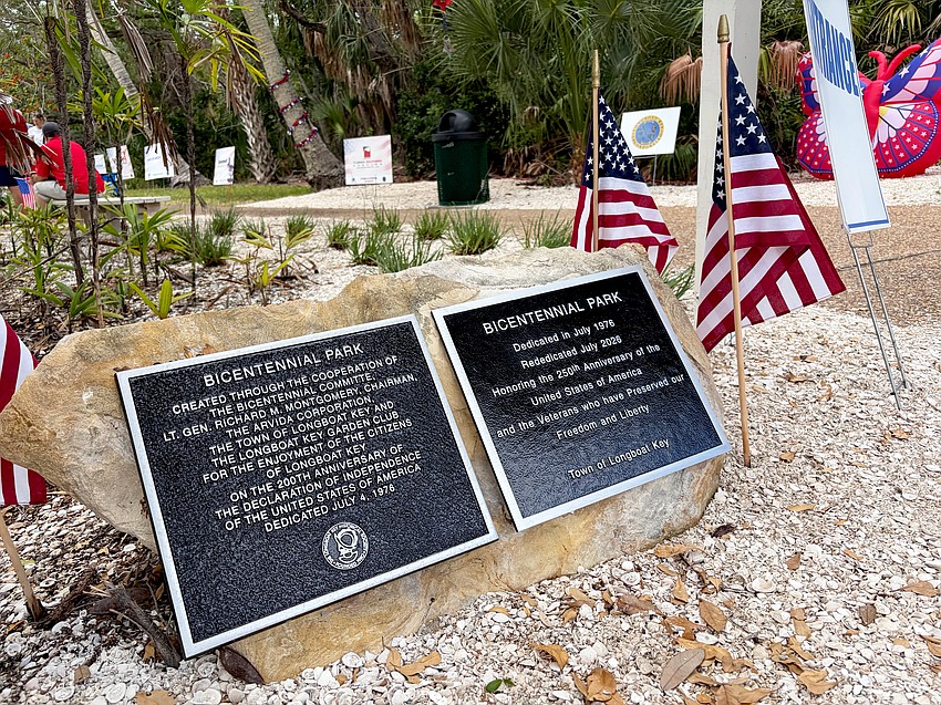 Plaques commemorating a very special Freedom Fest stand at the entrance to the newly-rededicated Bicentennial Park.