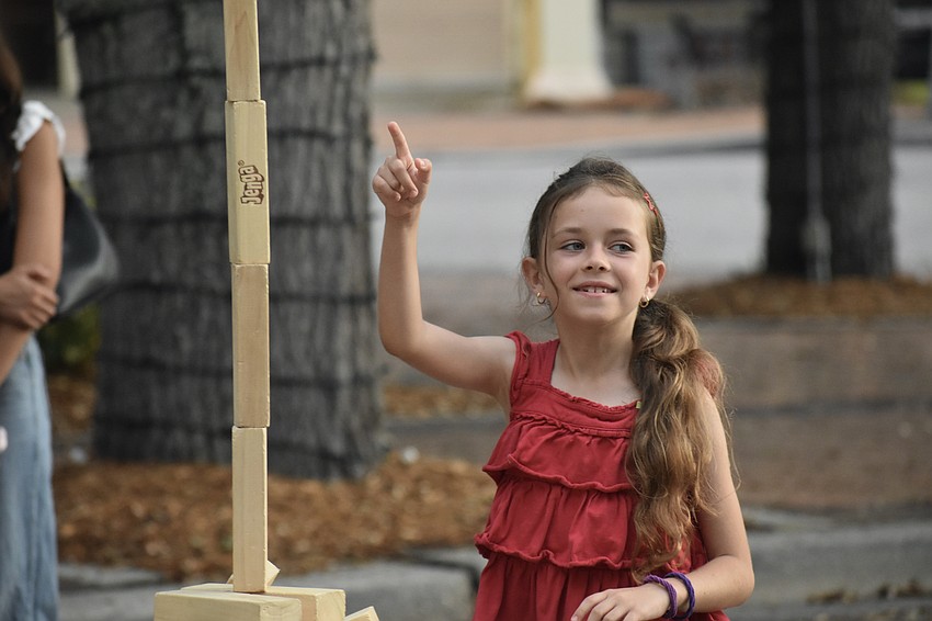 Stephanie Meyta, 8, points to a tower she created from Jenga blocks.
