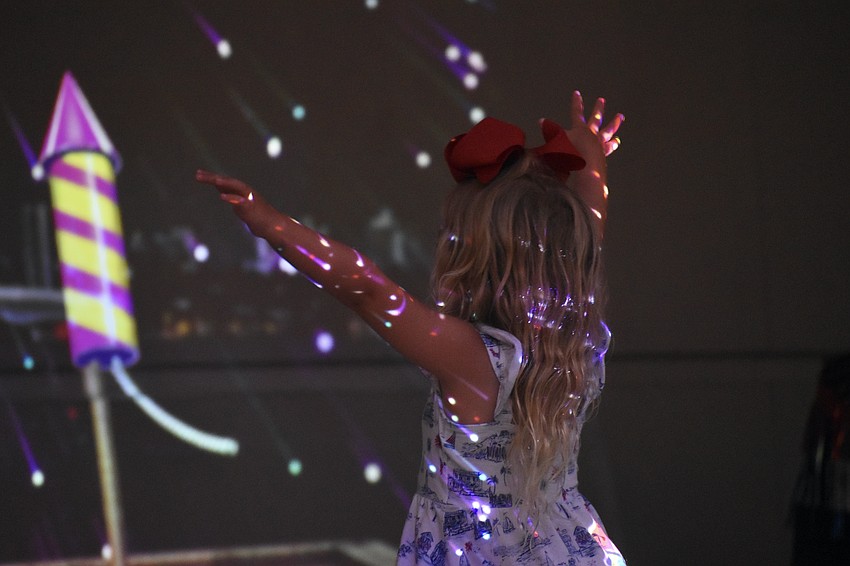 Carmela Barak, 3, launches fireworks in the 