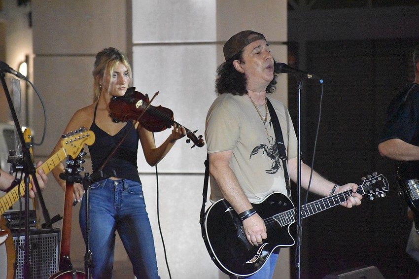 Adrianna Carr and singer/songwriter Mark Lorenzo, of Southbound 75, perform on stage.