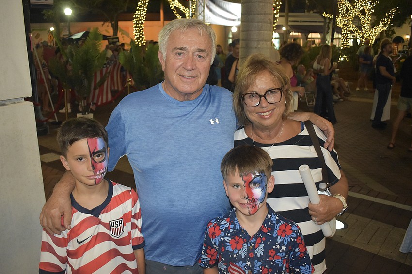 Nicholas Atkinson, 9, his grandparents Michael and Joanne Sciulli, and his brother Franco Atkinson, 7, enjoy the event together.