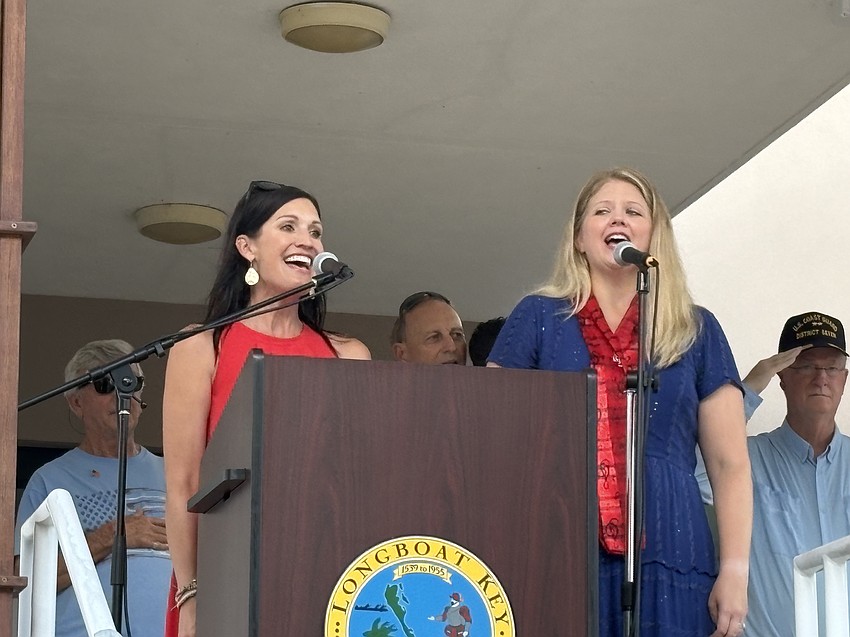 The Rev. Kim Munns Johnson and Alyssa Adamson from Longboat Island Chapel sing the national anthem at the rededication of Bicentennial Park during Freedom Fest.