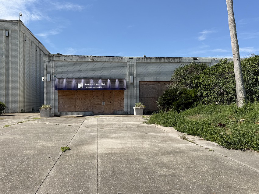 The former Regency Square Mall Management Office is boarded on the north-facing side of the property. The former Regency Square Mall Management Office is boarded on the north-facing side of the property.