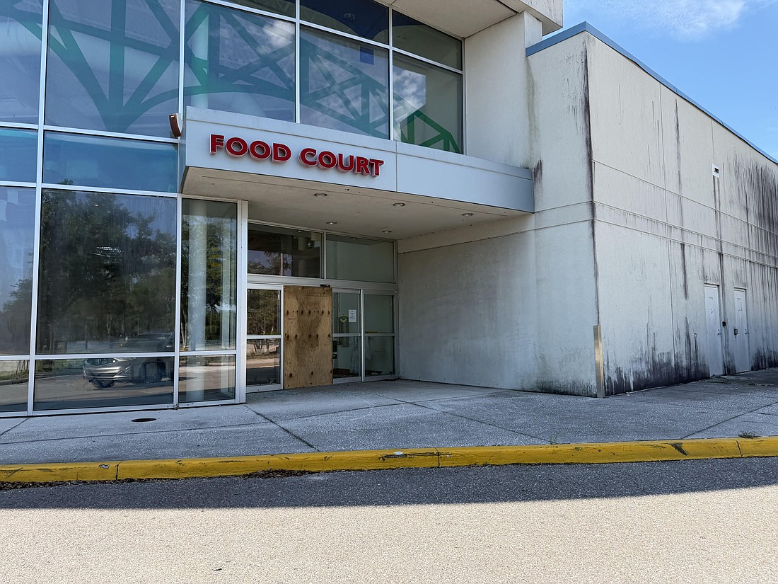 The former Regency Square food court door, one of the last access points into the east mall, is boarded shut.