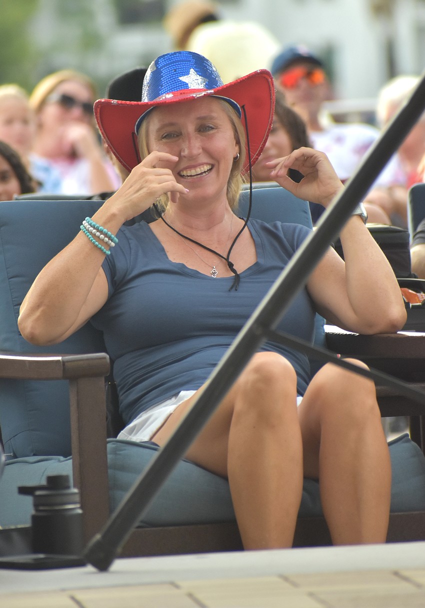 Sarasota's Keri Cifaretto, with her sequin-covered American cowboy hat, watches Noah Royak's comedy performance at the Star-Spangled Spectacular at Waterside Place.