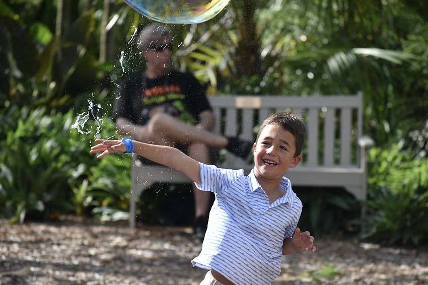 Xavier Keenan, 5, pops a bubble.