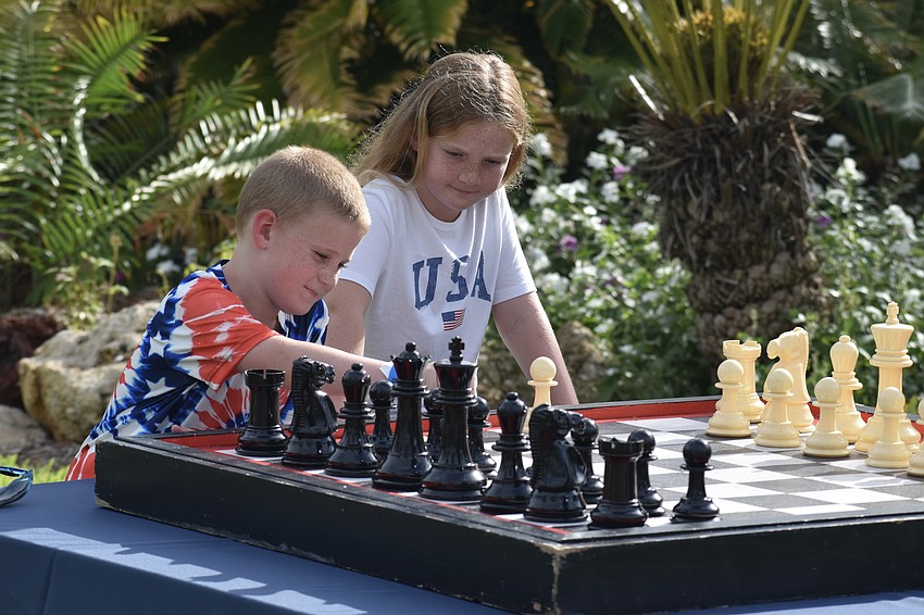 Hayes Smith, 6, and his sister Lindyn Smith, 9, play a game of chess.