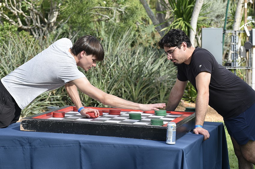 Gavin Mather and Gabe Messina play a game of checkers.