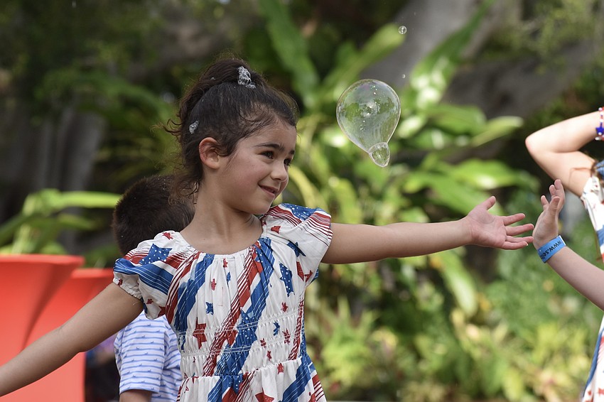 Isabel McLaughlin, 5, plays in the bubbles.
