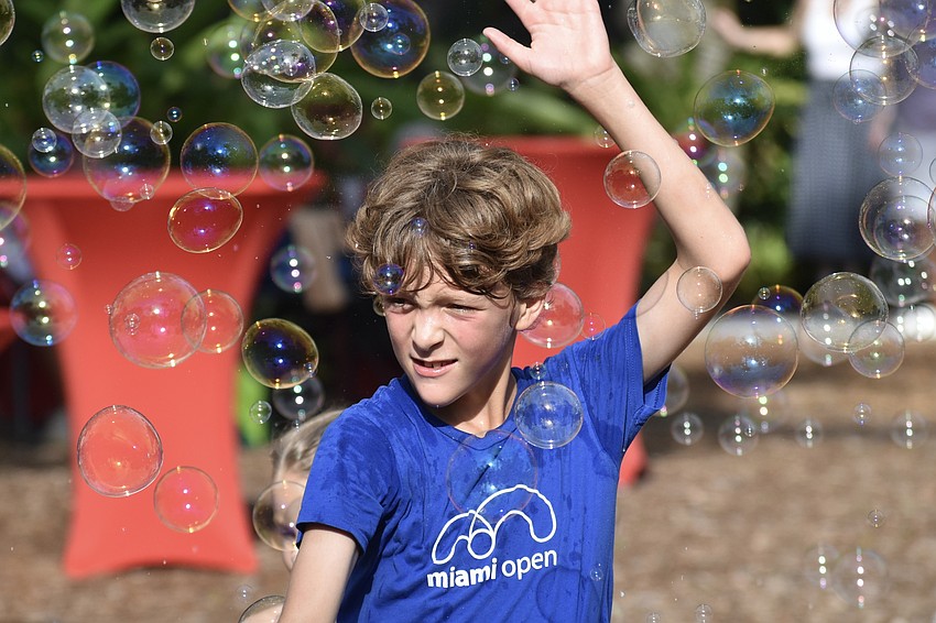 Mav Catts, 9, plays in the bubbles.